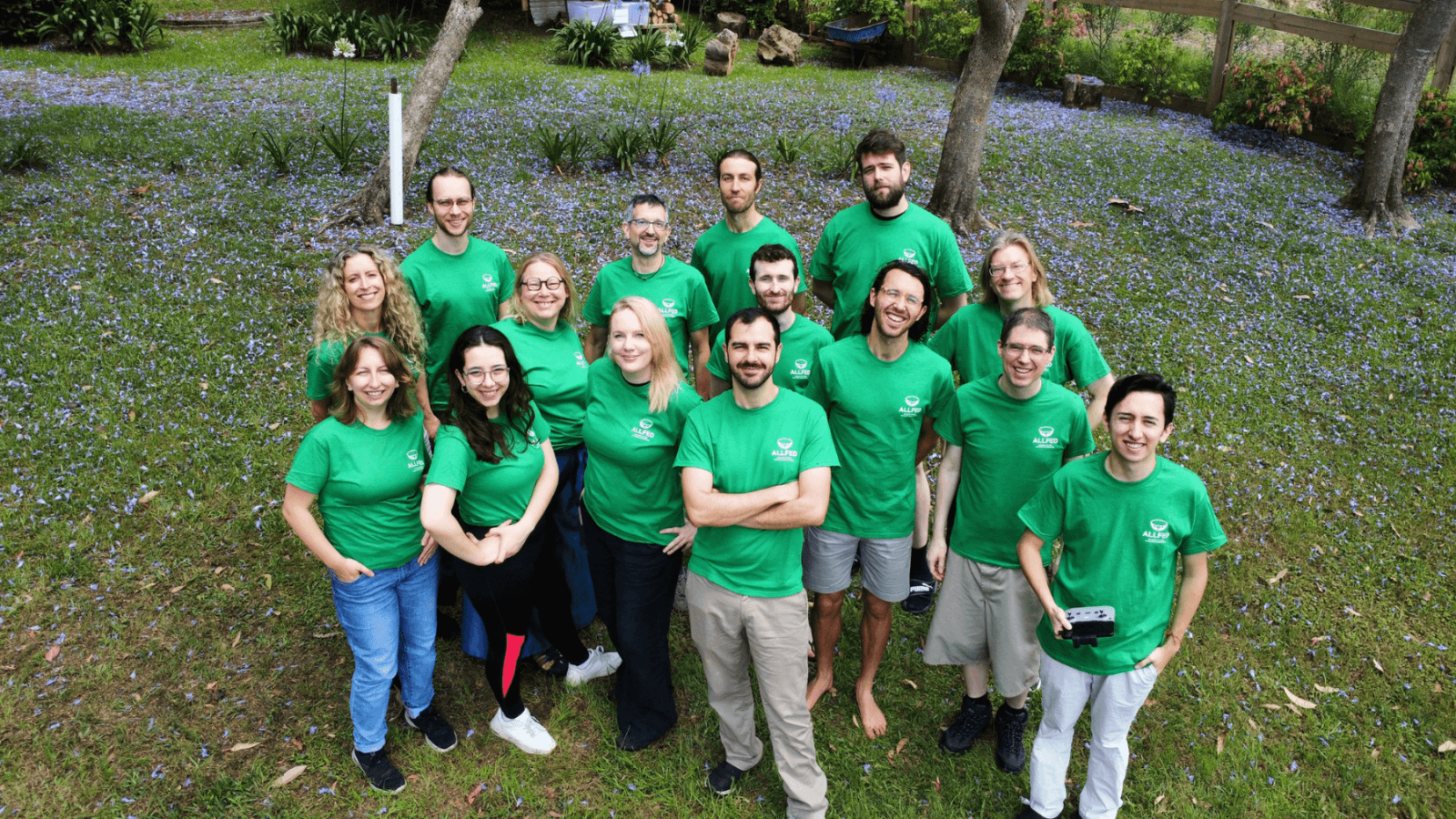 ALLFED team members wearing green t-shirts and looking up to the camera